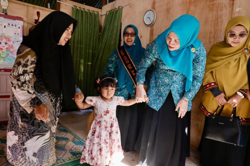 Bunda PAUD Aceh, Marlina Usman, menjemput seorang anak di Desa Jamur Konyel, Aceh Tengah, sebelum mengantarkannya ke PAUD sebagai wujud perhatian terhadap pendidikan anak usia dini di pelosok daerah, Selasa 26/8/2025 (Foto:Dok.Biro Adpim Setda Aceh)