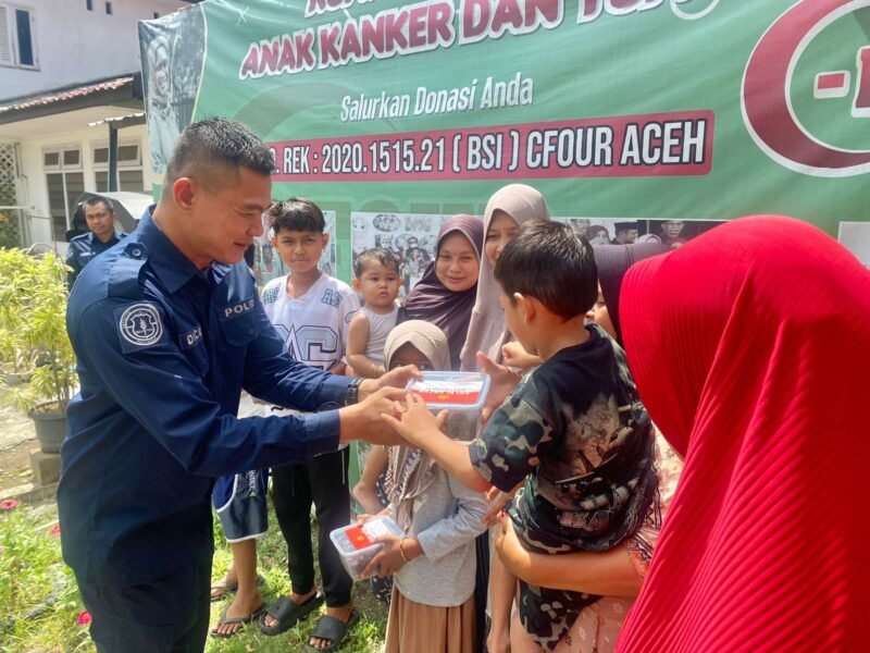 Personel Bidhumas Polda Aceh membagikan kurma bantuan Kapolda Aceh, Irjen Pol. Drs. Marzuki Ali Basyah, M.M., kepada warga di Banda Aceh, Rabu (11/3/2026).