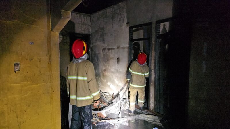 Petugas Damkar BPBD Aceh Besar melakukan pendinginan terhadap rumah yang terbakar, di Gampong Cot Mancang, Kecamatan Kuta Baro, Kabupaten Aceh Besar, Senin (13/7/2026) malam. FOTO/ DOK MC ACEH BESAR