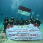 Seven police women (Polwan) from the Sabang Police Force perform a dive to unveil the Indonesian Red and White flag alongside a commemorative banner for the 78th Anniversary of Polwan in the underwater realm of Rubiah Island, Sabang, Aceh, on Tuesday, August 25, 2026.
