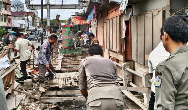 Satpol PP-WH Lhokseumawe tertibkan 15 kios di trotoar, parit & parkir Jl Listrik depan Pasar Inpres 7/10/2026 karena tutup saluran & ganggu kebersihan.